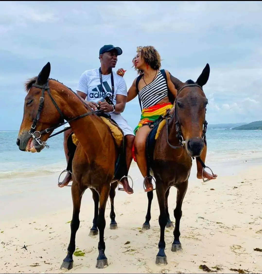 Guests horseback riding together on a Jamaican beach