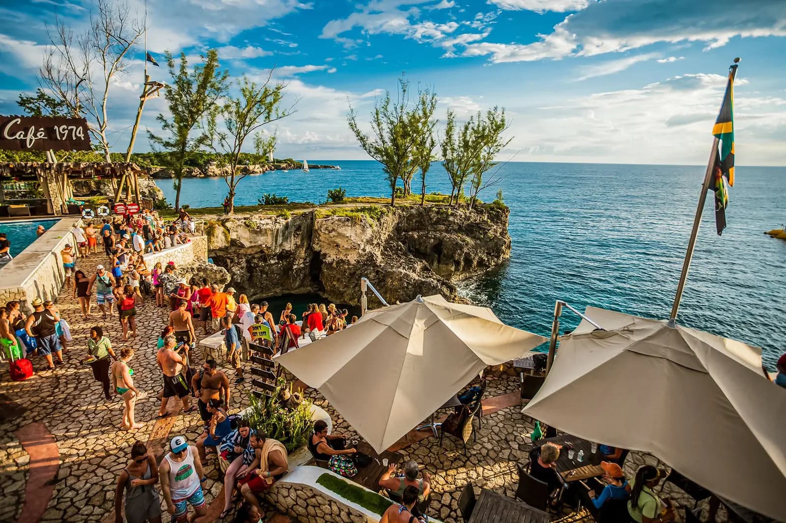 Guests enjoying the sunset at a Jamaican beach club